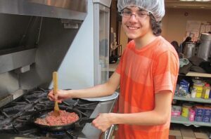 Jackson Chevarie prepares lunch at Church of the Redeemer. Photo: Contributed