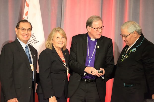 TRC Chair Justice Murray Sinclair, accompanied by Commissioners Wilton Littlechild and Marie Wilson, presents a digital copy of the historic final report to the primate, Archbishop Fred Hiltz. Photo: Art Babych