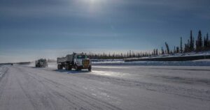 Photo of transport trucks on an ice road.